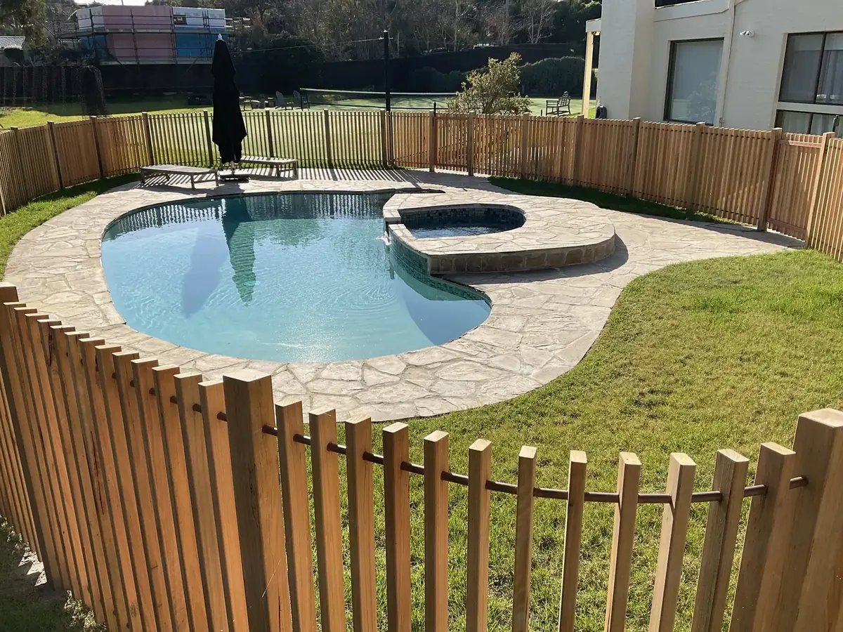 Curved timber pool fence following the shape of a residential swimming pool