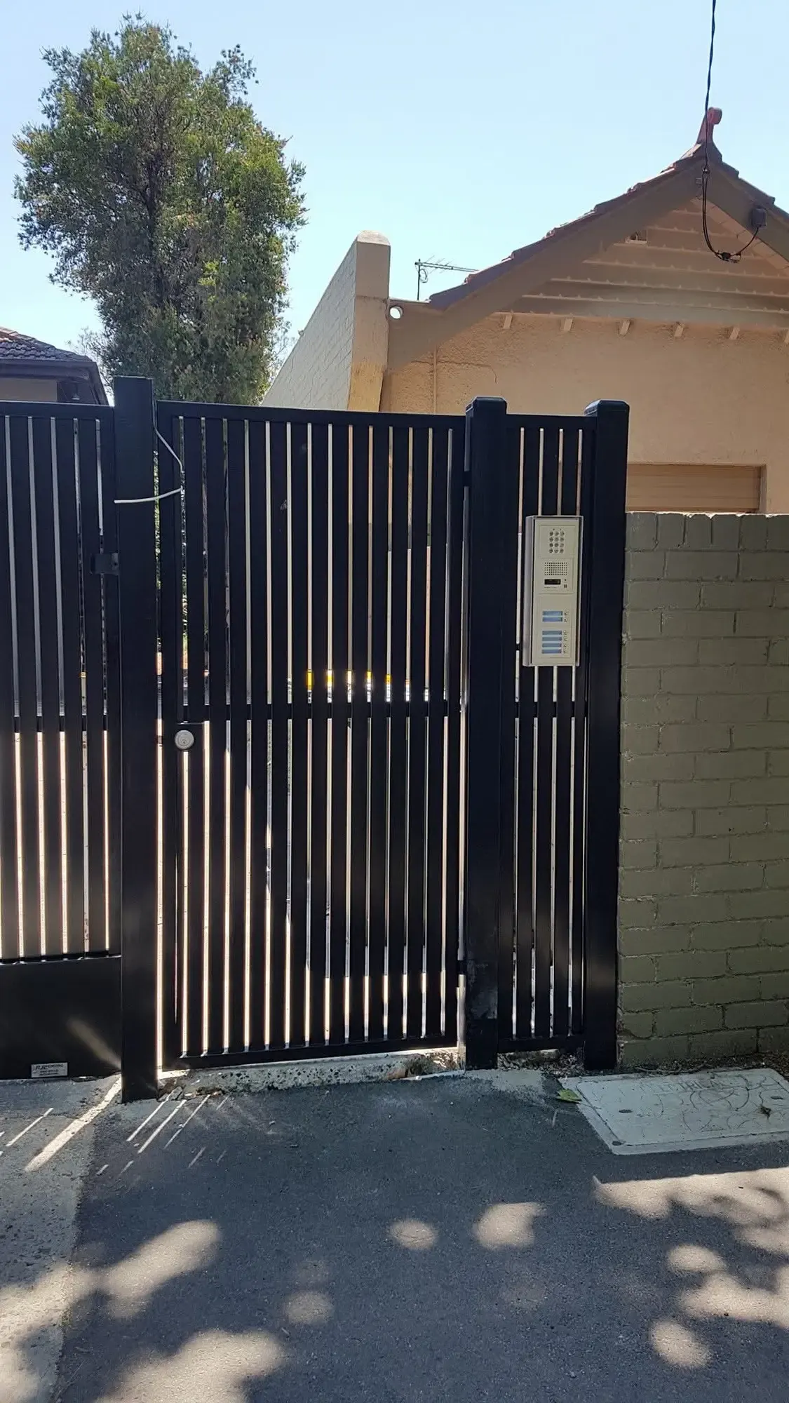 Pedestrian gate and intercom at the shared entrance.