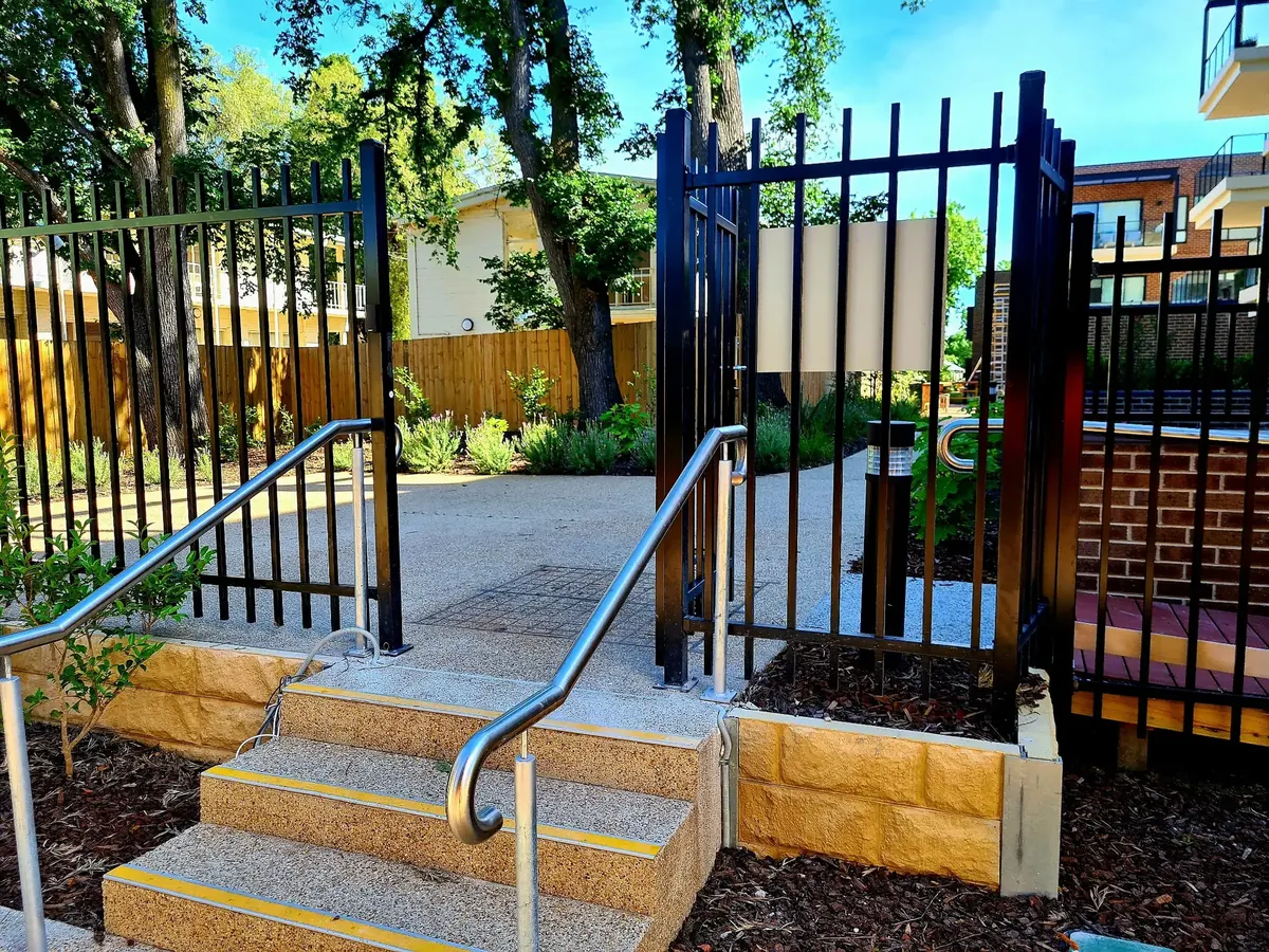 Completed black steel pedestrian gates and adjoining fencing at Uniting AgeWell Toorak.